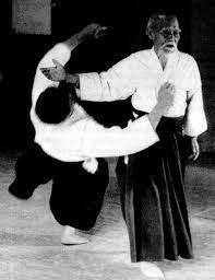 Morihei Ueshiba demonstrating a throw with a student